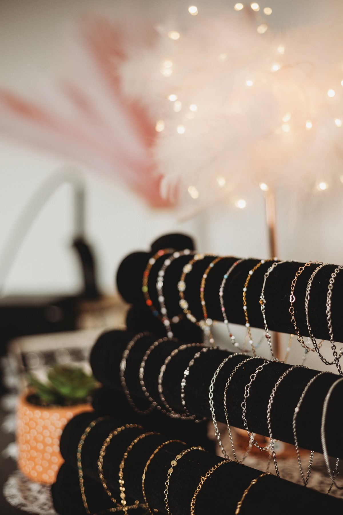 Stacked permanent jewelry chains displayed together